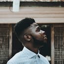 Close-up side profile of a thoughtful man outdoors in Mombasa, Kenya.